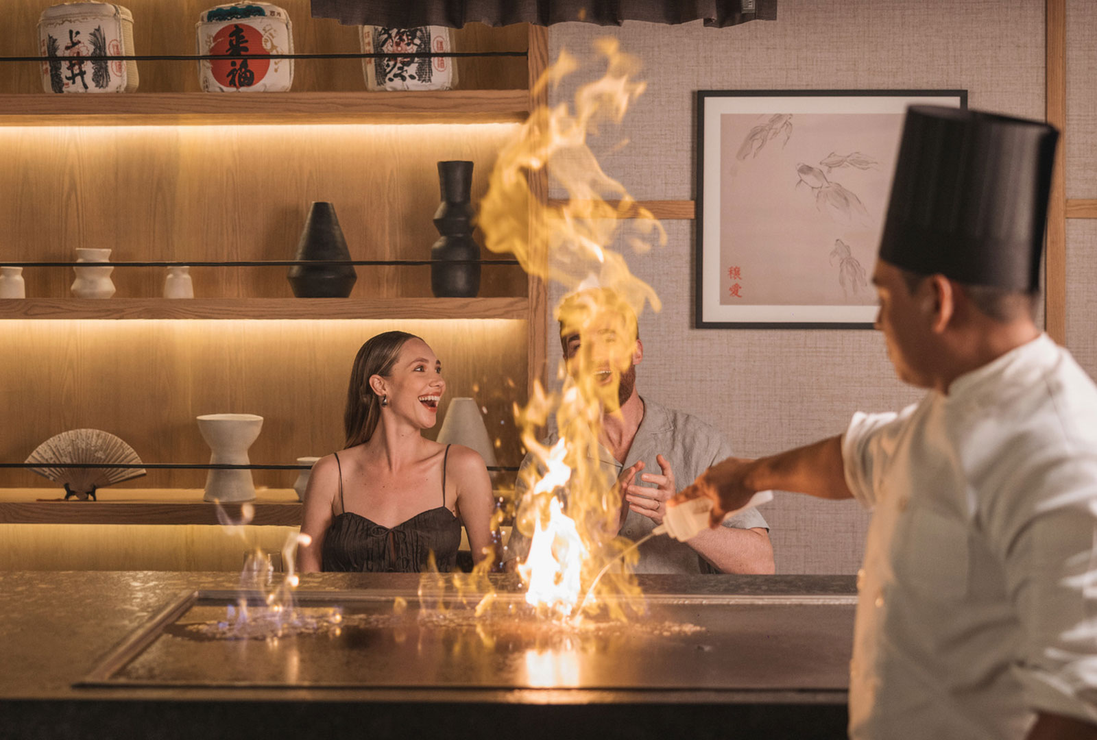 a man pouring a liquid into a fire